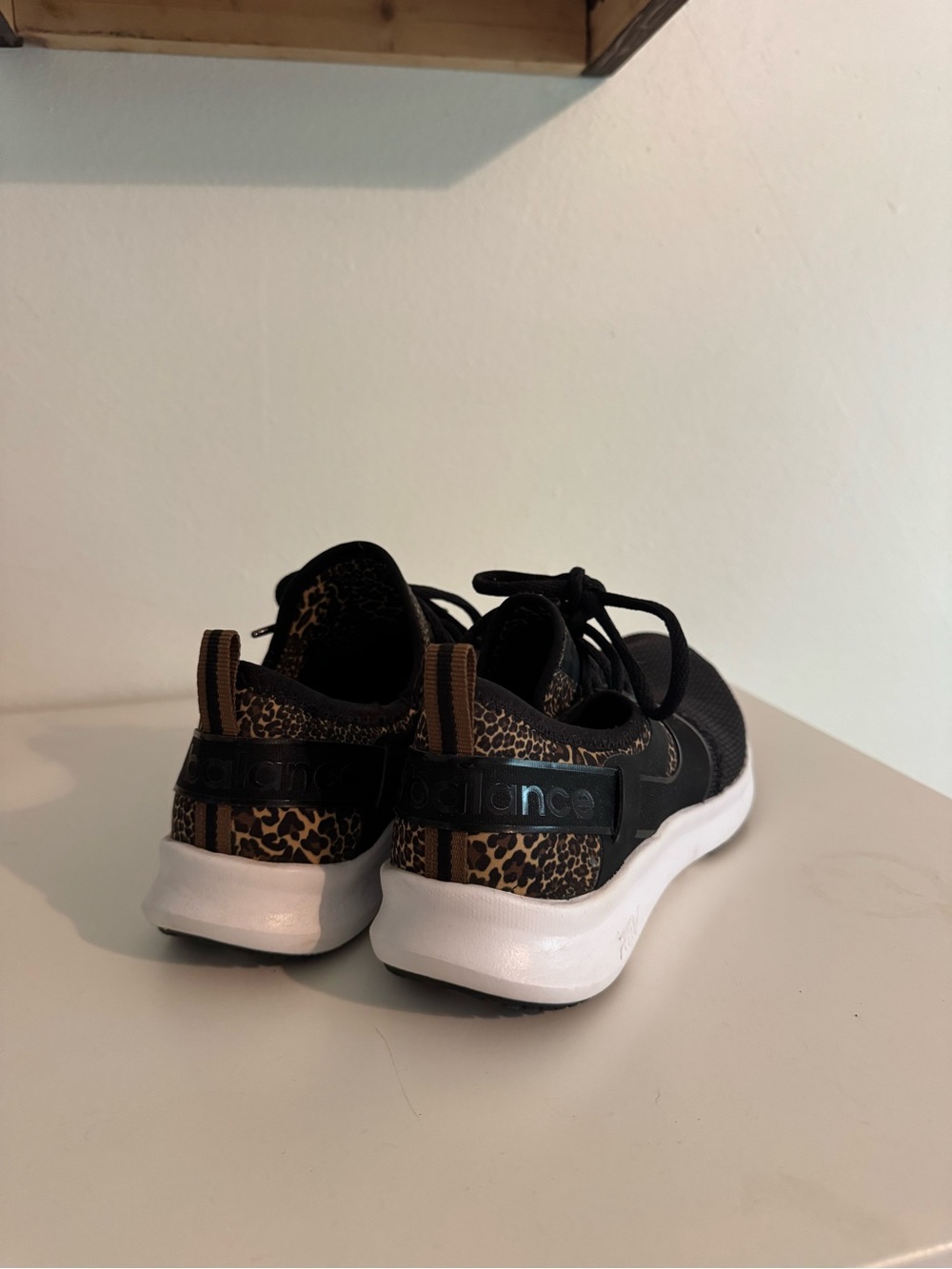 New Balance Black Sneakers with White Soles and Leopard Detail